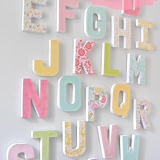 DIY Letter Wall - Make a big, colorful statement piece with an inexpensive home decor craft. {The Love Nerds} #letterdecor #modpodge #papermache #papercraft