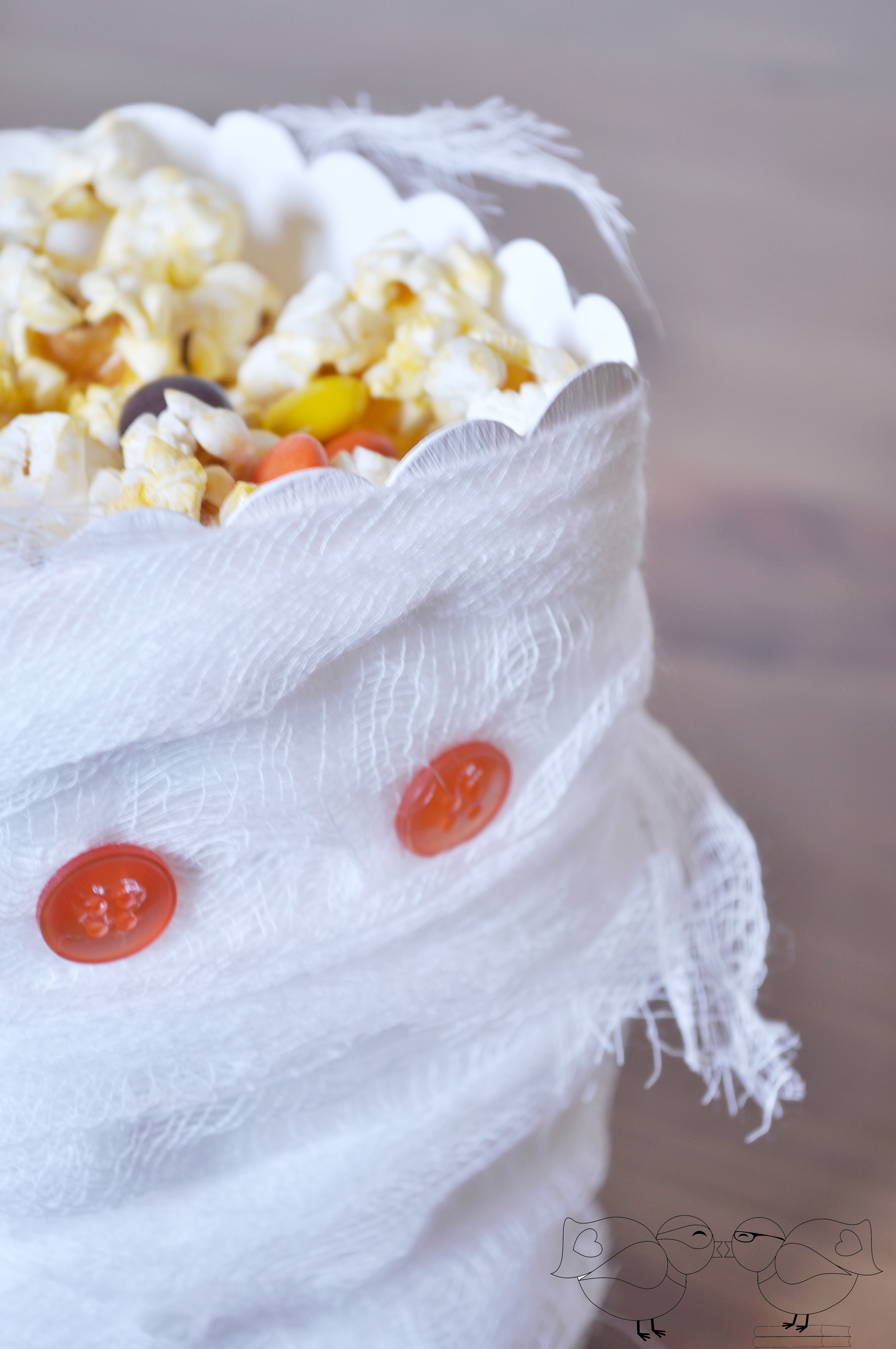 Up-cycle a popcorn box into a Halloween Favor Box. Dressed up as a mummy, it is the perfect addition to your Halloween Party! @ The Love Nerds {https://thelovenerds.com}