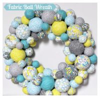 Fabric Ball Wreath - I am so excited about my spring wreath in aqua, lemongrass green, and gray patterns! It looks fabulous in our house and would look super cute in a nursery! {The Love Nerds} #crafts #springwreath