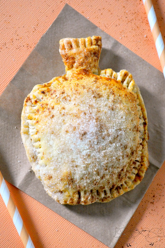Delicious and adorable Pumpkin Pecan Hand Pies! These individual pies, shaped like a pumpkin no less, are easy to make and even easier to serve! Perfect holiday food or a party dessert. {The Love Nerds}
