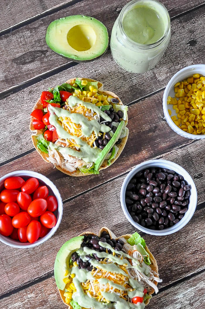 Chicken Taco Salad Recipe with a Jalapeno and Avocado Greek Yogurt Dressing - A light lunch or dinner idea that is the perfect use for leftover chicken! Prep time is quick making it a great weeknight meal! | The Love Nerds