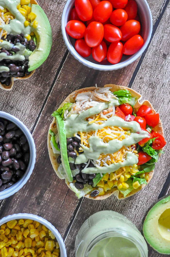 Chicken Taco Salad Recipe with a Jalapeno and Avocado Greek Yogurt Dressing - A light lunch or dinner idea that is the perfect use for leftover chicken! Prep time is quick making it a great weeknight meal! | The Love Nerds