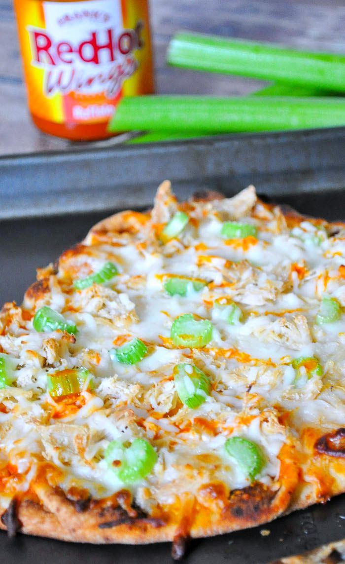 Enjoy delicious Buffalo Chicken Flatbread Pizza in under 20 minutes! Makes a great quick lunch or dinner idea and a crowd-pleasing game day appetizer. | The Love Nerds