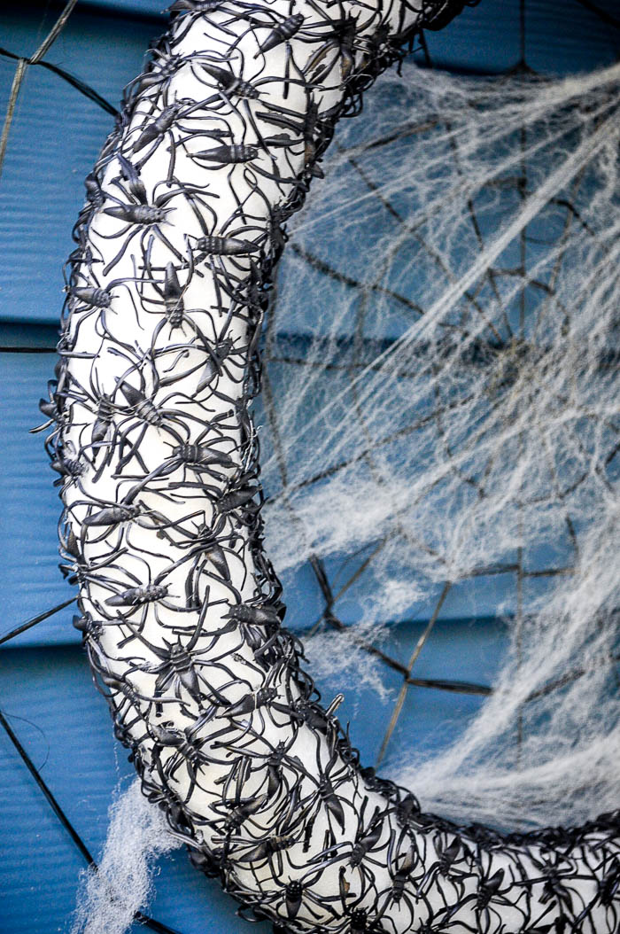 DIY Halloween Craft - This Spider Wreath is the perfect combo of creepy chic as it looks like black lace from afar. If you can hot glue, you can make this craft! | The Love Nerds