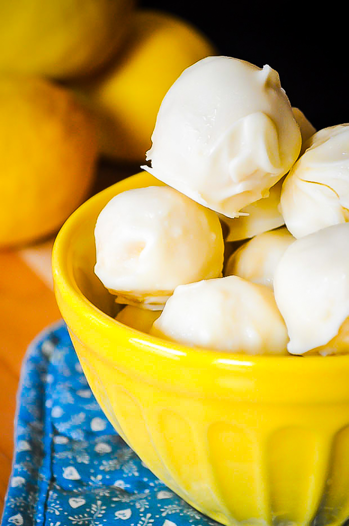 Lemon Coconut Truffles - A refreshing lemon dessert that's perfect for spring and summer! Creamy Lemon inside with a hint of coconut flavor and a white chocolate or vanilla almond coating! | The Love Nerds