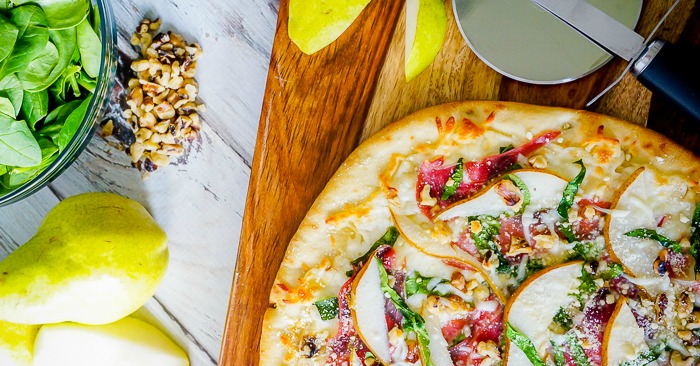 Spinach Pear Prosciutto Pizza with Honey and Walnuts is my favorite flatbread recipe so far! It's easy to make but will make quite the impression! | The Love Nerds