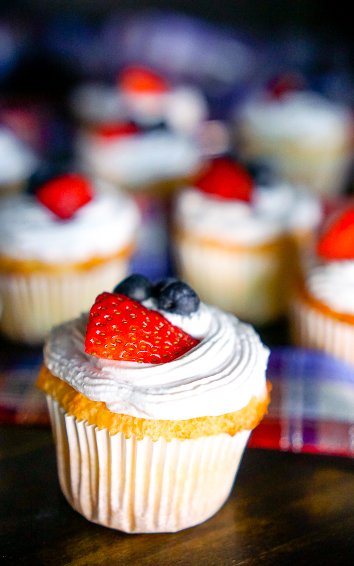 Angel Food Cake Cupcakes with Strawberry Whipped Topping - A light and airy summer dessert recipe that everyone will love! Plus with Red, White, and Blue, it makes a perfect 4th of July dessert! | The Love Nerds