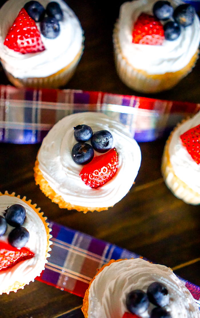 Angel Food Cake Cupcakes with Strawberry Whipped Topping - A light and airy summer dessert recipe that everyone will love! Plus with Red, White, and Blue, it makes a perfect 4th of July dessert! | The Love Nerds