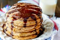 Sweet and Fluffy Churro Pancakes - This pancake recipe is addicting, especially when drizzled with chocolate sauce! | The Love Nerds