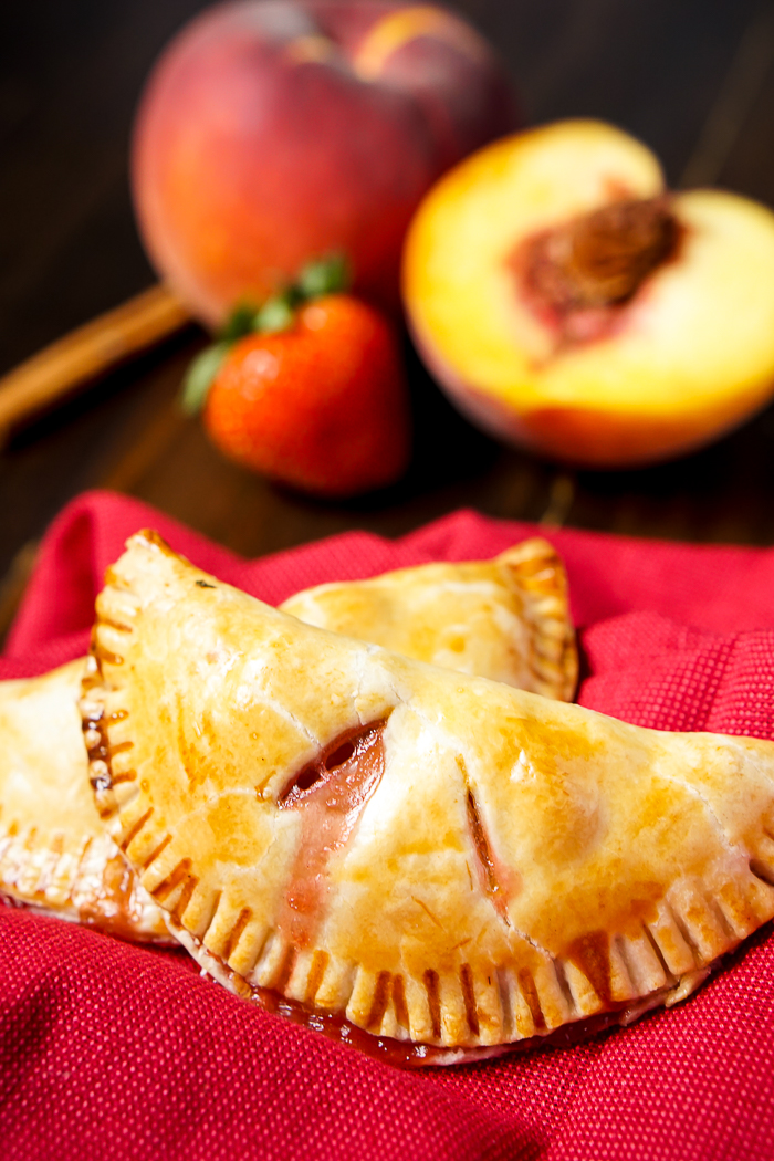 Strawberry Peach Hand Pies Recipe - Combine flavorful peaches with sweet strawberries to make a delicious hand pie filling! Fresh, tasty and easy to serve as party food! | The Love Nerds