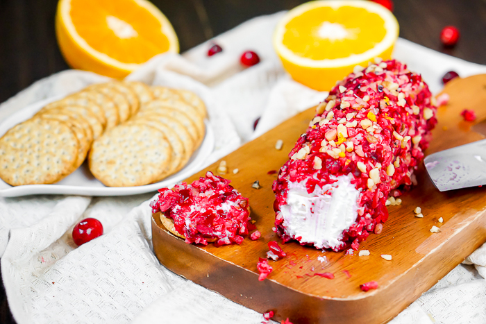 Cranberry Orange Goat Cheese Log with walnuts is a gorgeous and easy holiday appetizer recipe! Plus, it's a delicious cold appetizer to bring to a potluck! | The Love Nerds #holidayappetizer #cranberrygoatcheese #goatcheeselogrecipe