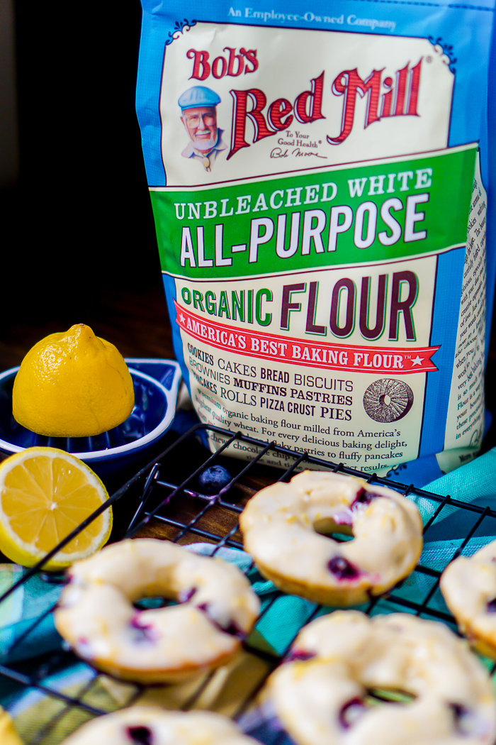 Baked Lemon Blueberry Donuts Recipe - Sweet and tangy flavors combine for the perfect baked donut! Make this breakfast recipe for your next holiday or brunch! | The Love Nerds AD BobsSpringBaking @BobsRedMill