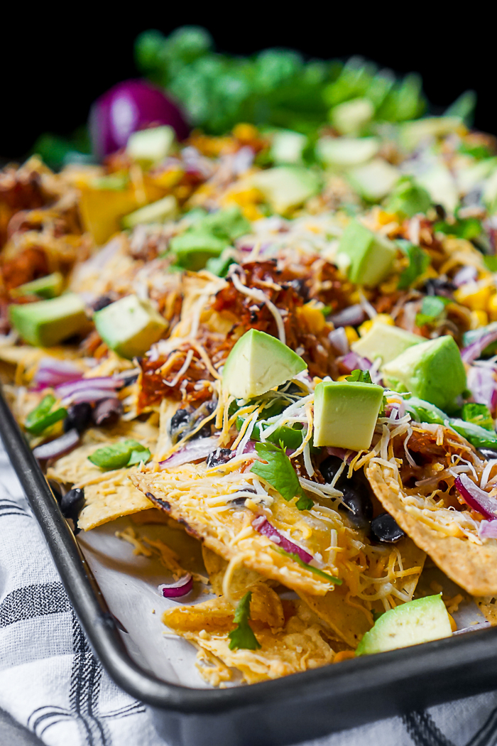 BBQ Pulled Pork Nachos - A tasty dinner or game day appetizer that only takes 15 minutes to make! Baked Nachos are always a quick and fun addition when menu planning! | The Love Nerds