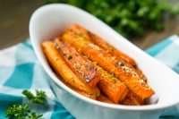 This easy holiday side dish is kid approved! Oven roasted carrots with brown sugar add a little sweetness to traditionally savory carrots. Everyone will love these brown sugar carrots! | The Love Nerds #holidaysidedish #sidedishrecipe #carrotrecipe