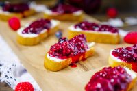 This Berry Goat Cheese Crostini recipe is an easy goat cheese appetizer that provides the perfect combination of creamy goat cheese, sweet three berry jam and a crunchy homemade crostini. 