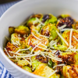 These oven roasted Brussels sprouts are lightly seasoned with garlic and parmesan, resulting in a winning flavor combination the whole family will love! Fresh, crunchy and so easy to make, this Brussels sprouts side dish is a winner!  