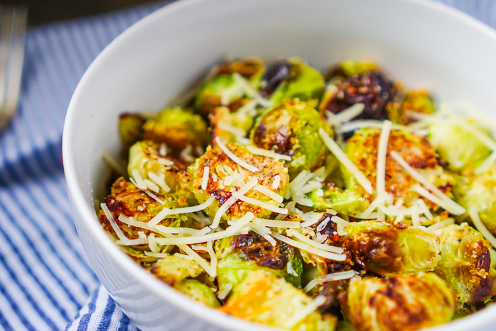 These oven roasted Brussels sprouts are lightly seasoned with garlic and parmesan, resulting in a winning flavor combination the whole family will love! Fresh, crunchy and so easy to make, this Brussels sprouts side dish is a winner!  