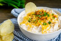 Everyone needs to have their go-to easy chip dip recipe for parties and get togethers, and this loaded potato dip recipe is mine! Add classic baked potato toppings to a sour cream chip dip base and serve on your favorite potato chip. Mix together this party appetizer in 5 minutes and enjoy! 