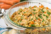 This easy chicken casserole recipe is a fun twist on the classic chicken and wild rice soup that the whole family will love for dinner all year long! Combine chicken, wild rice, carrots, celery, onions, seasoning and a light cheese sauce for a tasty Chicken and Wild Rice Casserole dinner! 