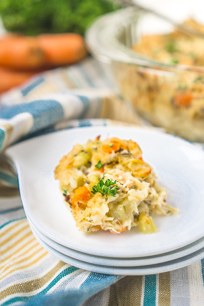 This Chicken and Wild Rice Casserole recipe will become a new staple for your family dinners! Chicken, wild rice, carrots, celery, onions, seasoning and a light cheese sauce combine into a delicious and easy chicken casserole! 