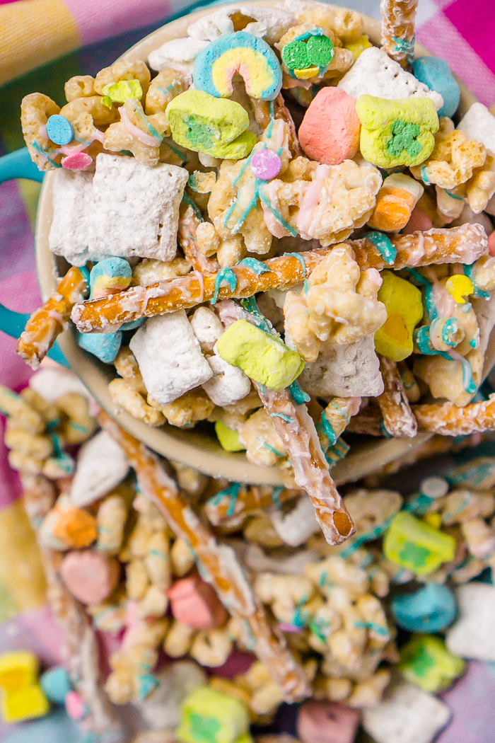 St Patrick’s Day Puppy Chow with Lucky Charms Marshmallows, Lucky Charms Cereal, Pretzel Sticks, Chex Mix Cereal, and sprinkles!! I’m always on the look out for kid friendly recipes for St Patrick’s Day and this is definitely a winner for kids and adults, alike! 