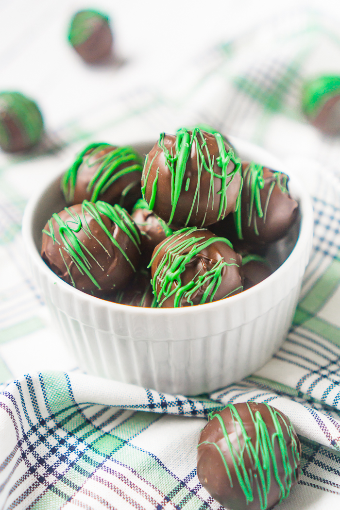 Thin Mint Truffles made with grasshopper cookies, cream cheese and chocolate coating! Tasty and flavorful, these chocolate truffles are a kid friendly recipe for St. Patrick’s Day! 