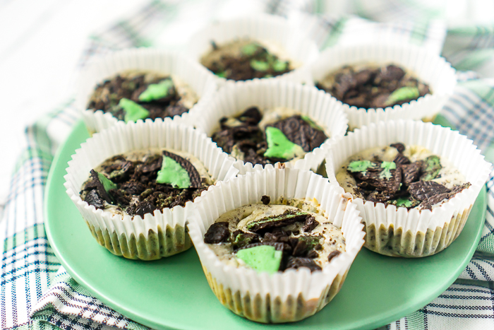 My obsession with mini cheesecakes continues with a tasty St. Patrick's Day Cheesecake recipe - Mint Oreo Cheesecake! A creamy cheesecake filling with crushed Oreos is baked on top of a Mint Oreo crust. Add a little extra Mint Oreo crumble on top for a touch of green on this St. Patrick's Day dessert everyone will love! 
