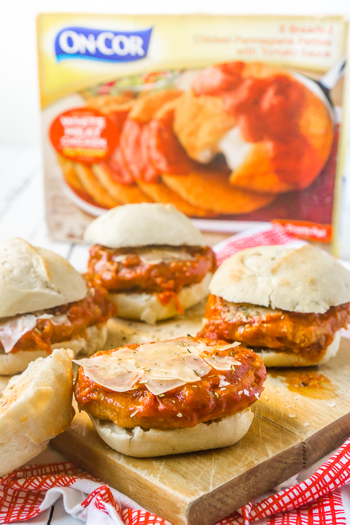 Chicken Parmesan Sliders are an easy dinner recipe that you're whole family will love! White meat chicken, fresh mozzarella, and savory tomato sauce on top of fresh rolls make a delicous sandwich that requires less than 5 ingredients and less than 15 minutes of prep work! 