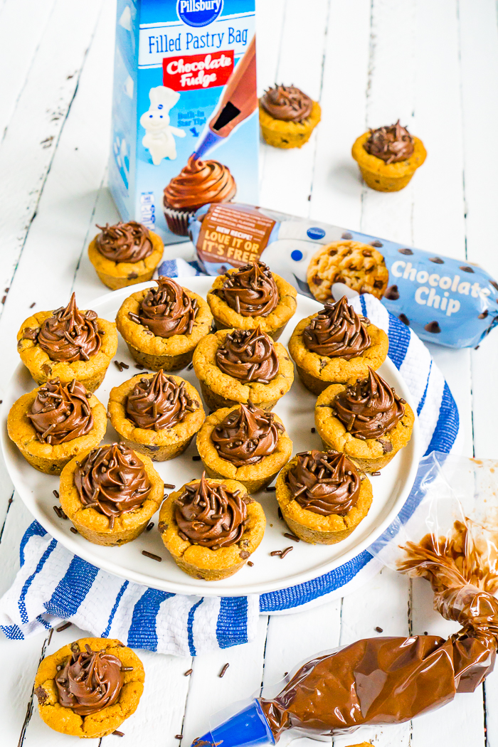 Frosted Chocolate Chip Cookie Cups combine two favorite sweets- chocolate chip cookies & chocolate fudge frosting! This dessert is ready in just 30 minutes. 