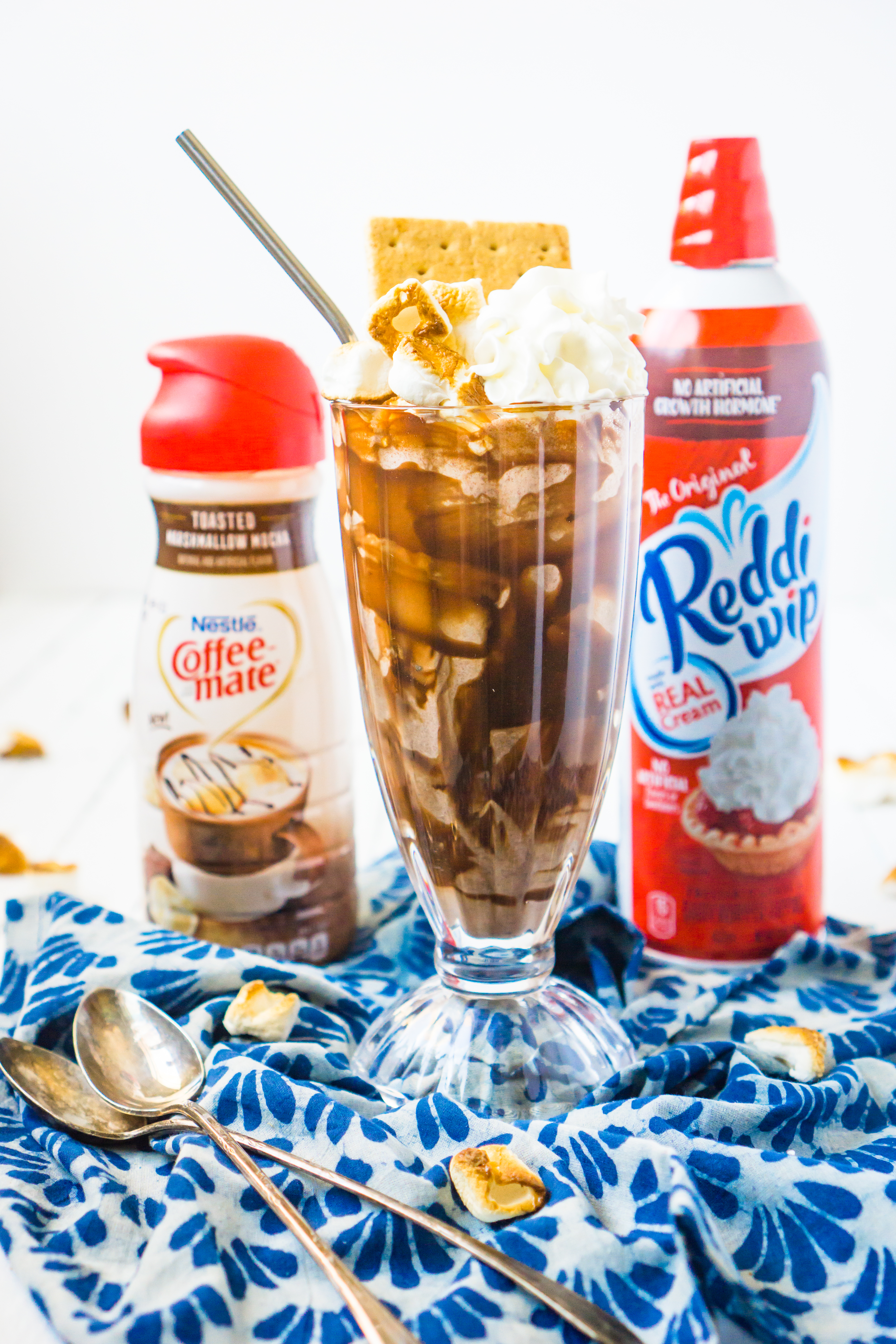 Stay cool this summer by taking the classic summer dessert away from the fire pit and into a tasty and refreshing S'Mores Milkshake! With chocolate ice cream, graham crackers, COFFEE-MATE® Toasted Marshmallow Mocha Liquid Coffee Creamer and a generous dollop of Reddi-wip, you are going to want to share this summer ice cream treat with all your friends and family! 