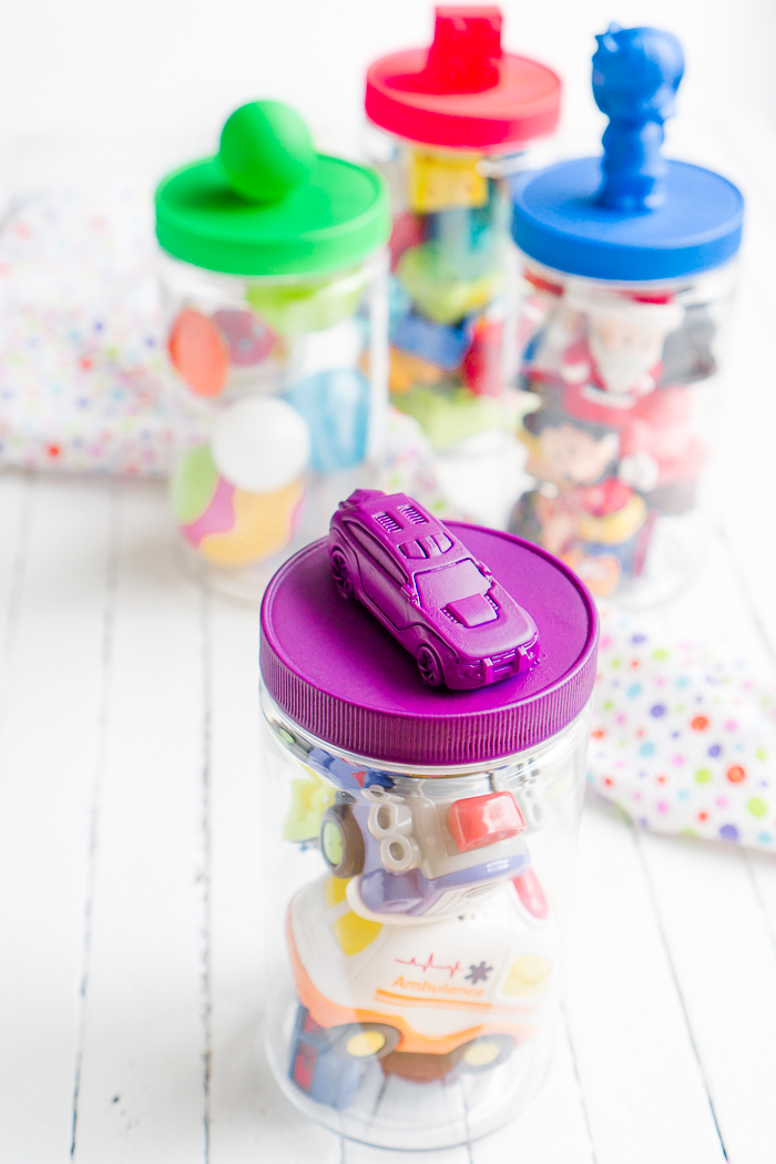 All parents know that the playroom can easily become a huge mess so I've created some colorful DIY Playroom Storage Containers! Create lids with easily identifiable toy labels in bright colors thanks to Plasti Dip. 