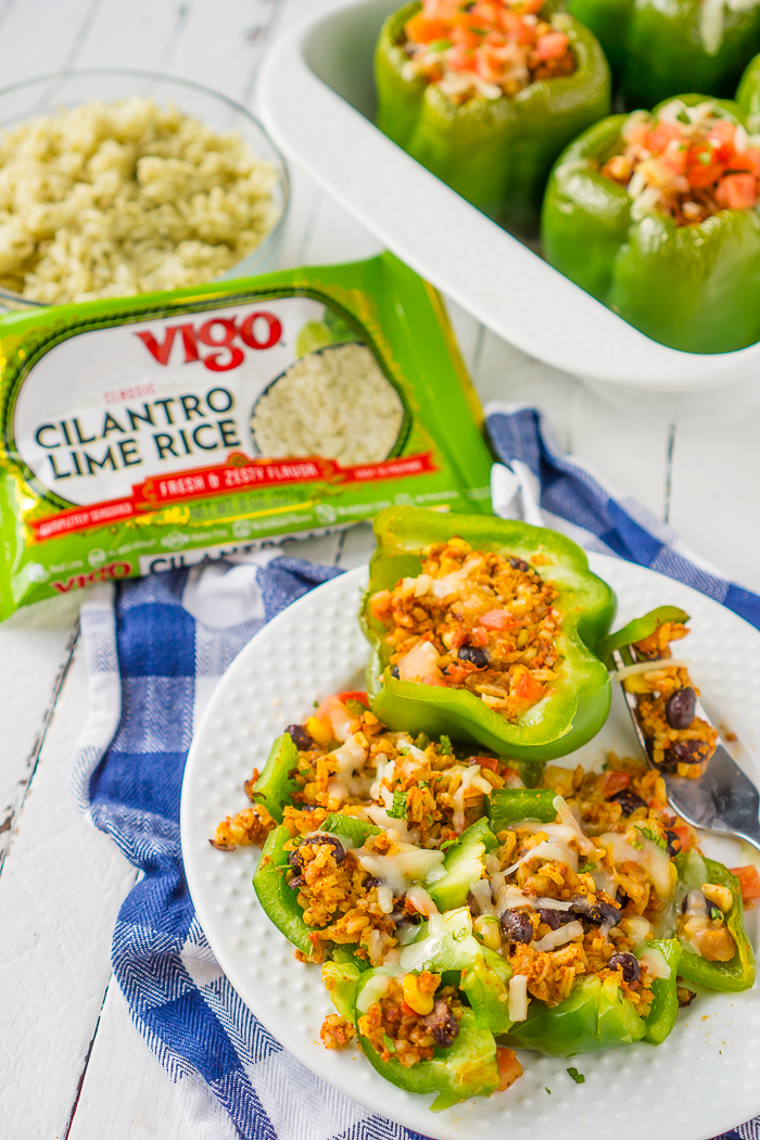 We love Chipotle over here, but don't always want to spend the money. Enter Burrito Bowl Stuffed Peppers! This stuffed pepper recipe is filled with delicious cilantro lime rice, spicy chorizo, corn, pico de gallo and more! They are filled to the brim with tasty ingredients! | THE LOVE NERDS
