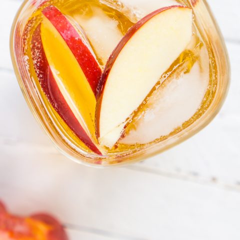 Celebrate Katniss Everdeen with this Hunger Games inspired cocktail - The Girl on Fireball Cocktail! OR just celebrate your love of perfect fall cocktail recipes and combine spiced Fireball Whiskey with tasty cider! | THE LOVE NERDS #fireballwhiskey #fallcocktail