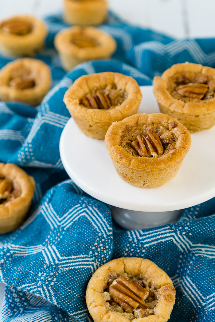 Delicious warm, brown sugar Pecan Pie filling in sweet sugar cookie cups makes the perfect Thanksgiving cookie - Pecan Pie Cookie Cups! Your family won't be able to stop eating this addicting fall dessert! | THE LOVE NERDS