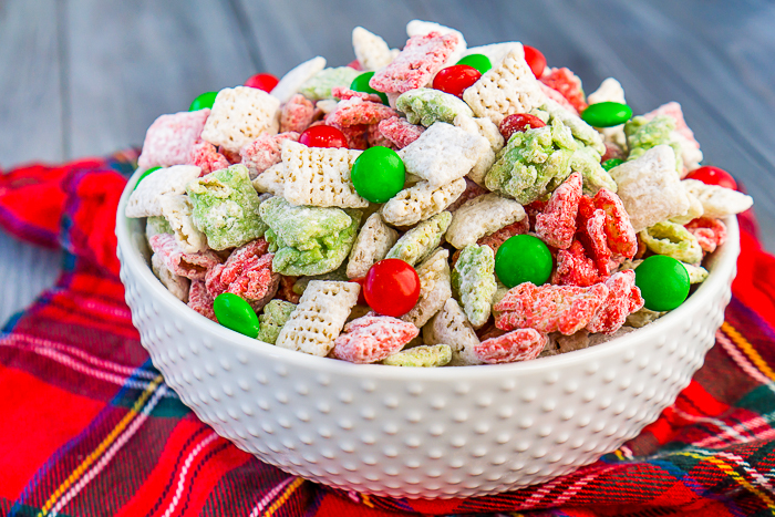 Let's not leave the reindeers out this holiday season by making them their own special Reindeer Chow {aka Christmas Puppy Chow}! This holiday party mix recipe is filled with festive white, red, and green to celebrate the season!! Perfect for your Christmas parties or gift exchanges with neighbors and friends. | The Love Nerds