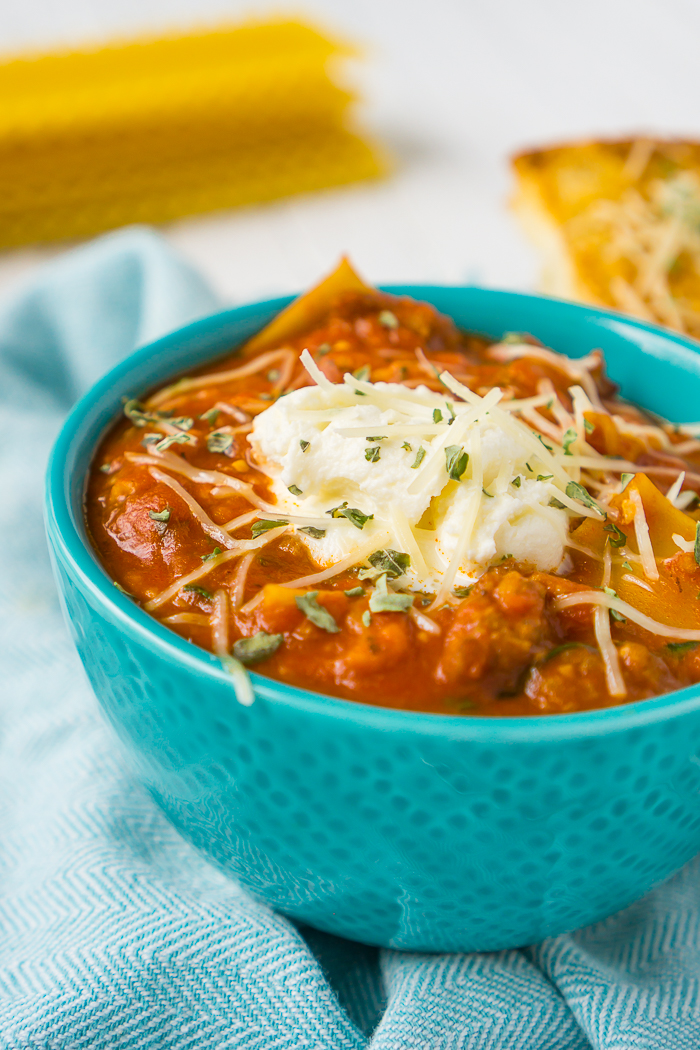 Looking for a warm new soup to add to your winter menus? Then this One Pot Lasagna Soup is for you! Full of Italian sausage, tomatoes, spinach, cheese and lasagna noodles, it has all the yummy flavors of a lasagna without all the time and work! | THE LOVE NERDS