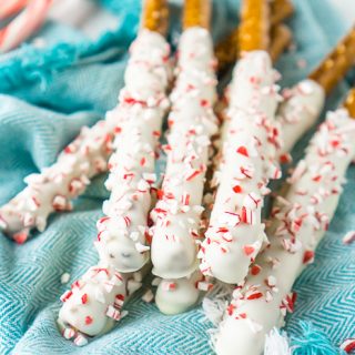 White Chocolate Peppermint Pretzel Rods are the Christmas candy recipe you didn't know you needed, but you do! Add the perfect touch of peppermint to classic chocolate pretzel sticks. | THE LOVE NERDS #christmascandy #christmasdessert #candyrecipe #holidayrecipe