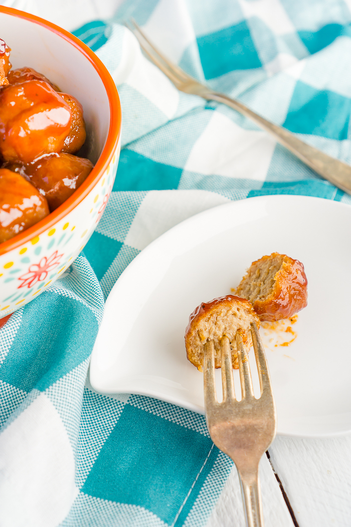 Delicious Peach BBQ Meatballs are quickly tossed together to cook in the slow cooker for a tasty game day recipe or easy weeknight dinner! Packed full of protein, these are the perfect combination of sweet and smokey.  | THE LOVE NERDS #meatballrecipe #gamedayappetizer #partyfood #easydinner